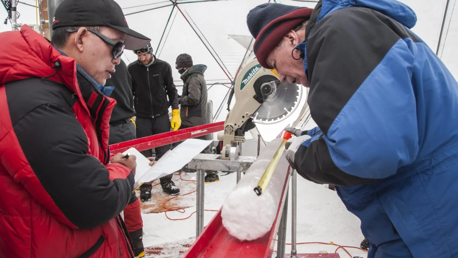 Yao Tandong, left, and Lonnie Thompson, right, process an ice core drilled from the Guliya Ice Cap in the Tibetan Plateau in 2015